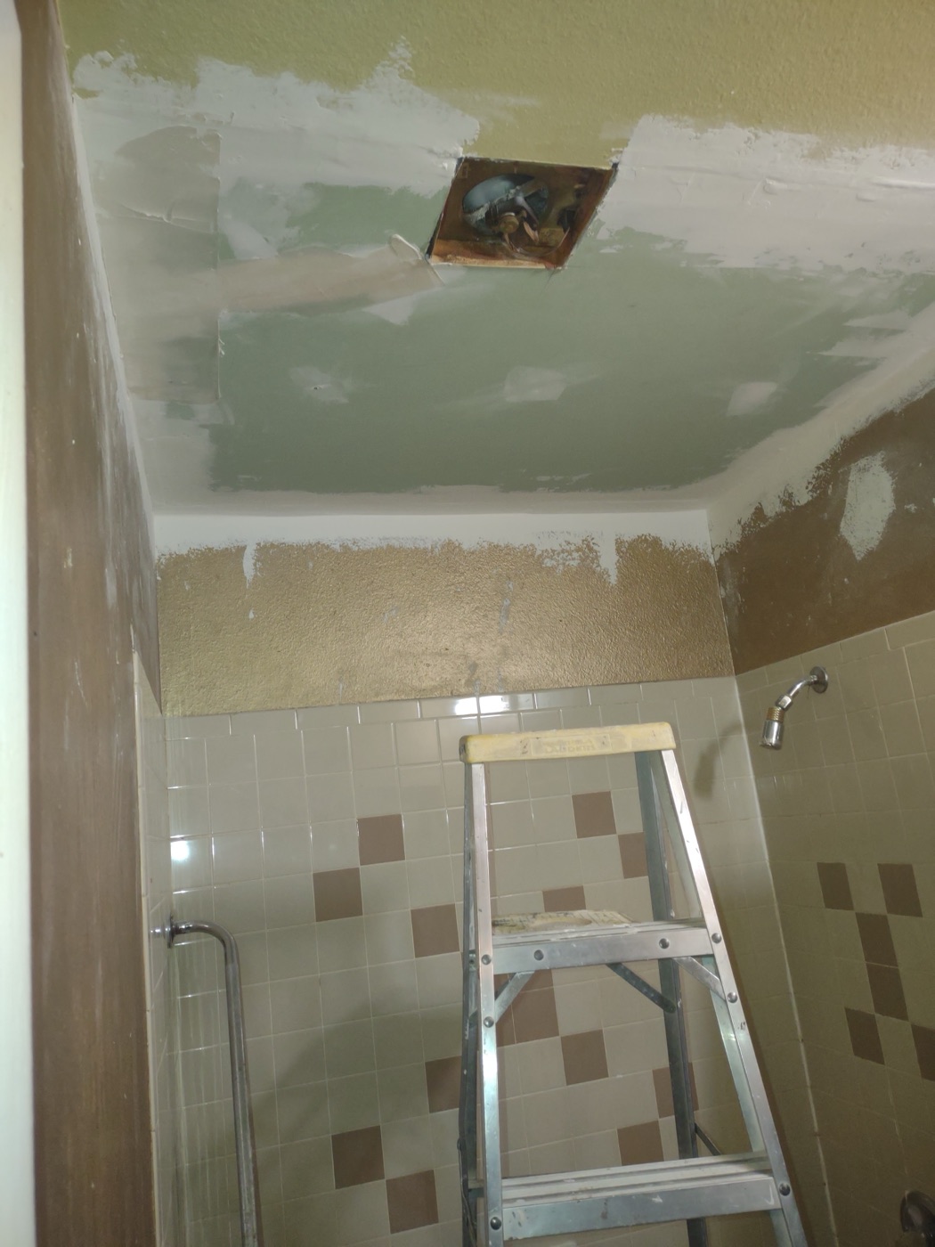 Moisture-resistant drywall installed and mudded on bathroom ceiling